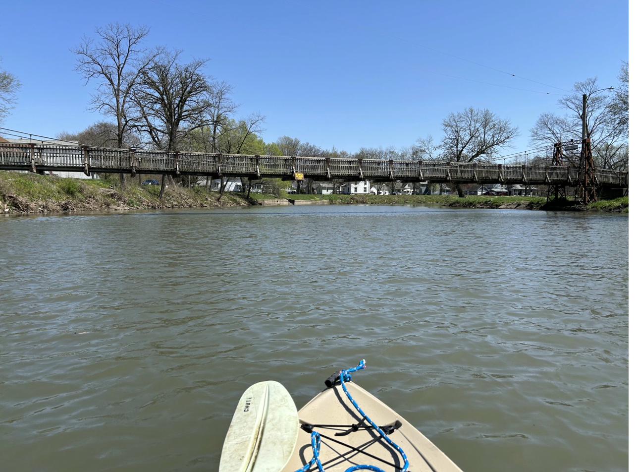 Kayak approaching a swinging bridge on the Vermilion River in Pontiac